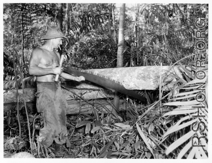 GIs cutting bucking downed trees in Burma for lumber mill.  During WWII.  797th Engineer Forestry Company.