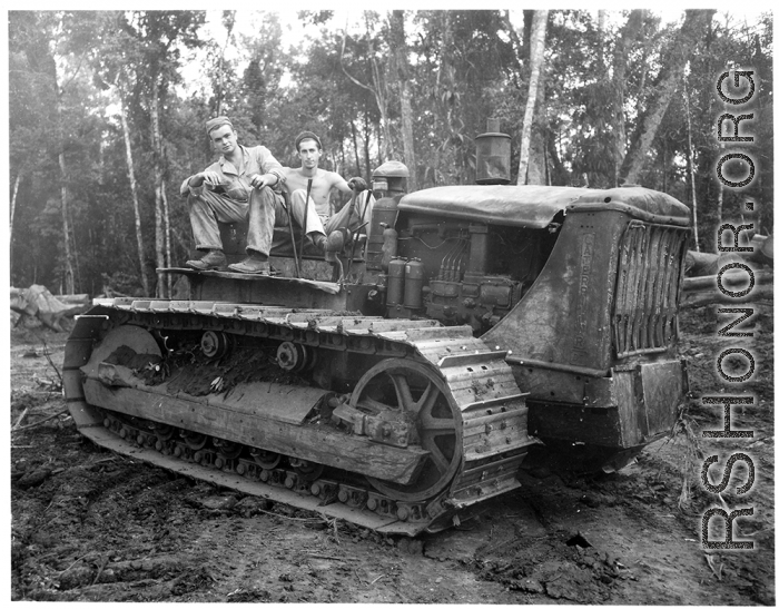 GIs pose on bulldozer in Burma.  797th Engineer Forestry Company in Burma.  During WWII.