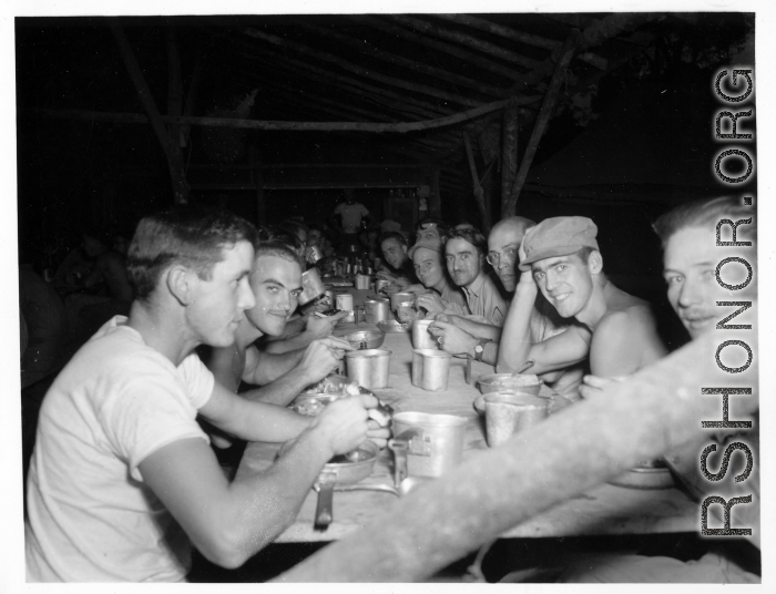 Engineers of the 797th Engineer Forestry Company eating meal at camp in Burma.  During WWII.