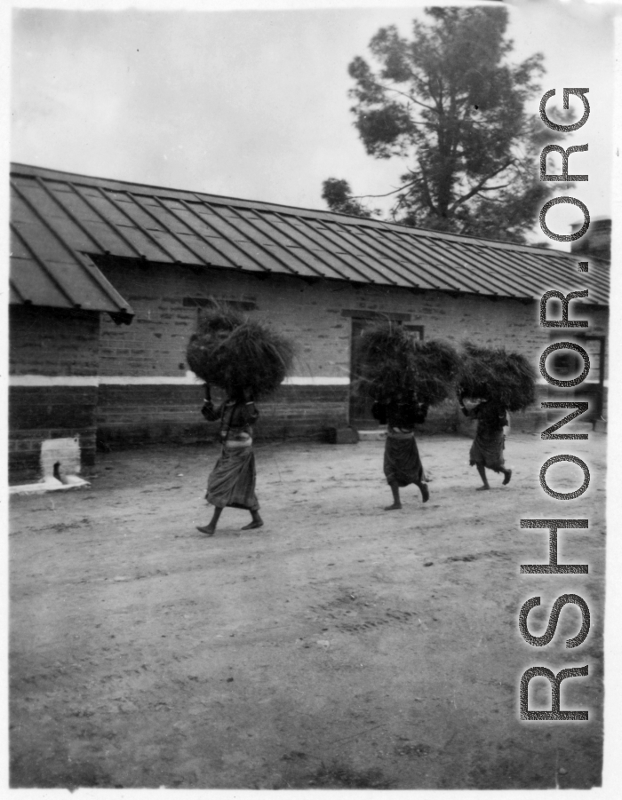 Local women shoulder large bundles of brush at the American military Darjeeling Rest Camp, Darjeeling, India, during WWII.