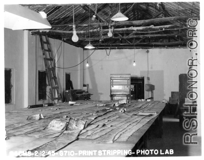 "Print Stripping" at photo lab of the 24th Mapping Squadron--laying out related photographic prints as they were photographed on the negatives. February 12, 1945.