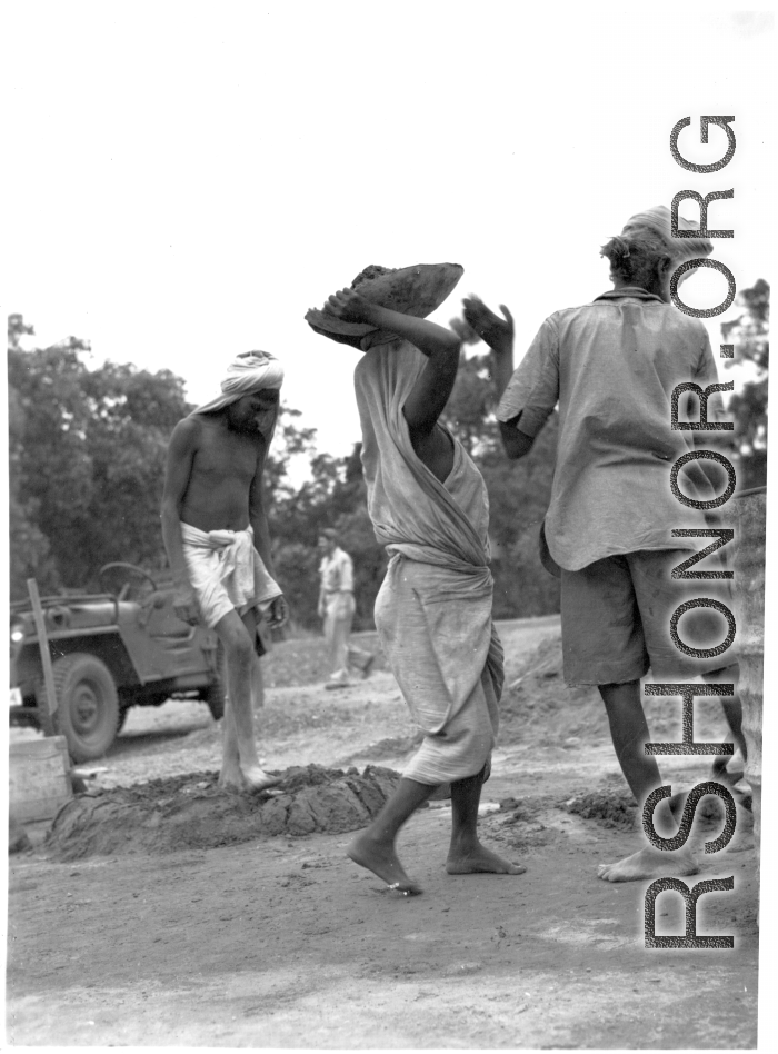 Laborers work at an American base in India, during WWII.