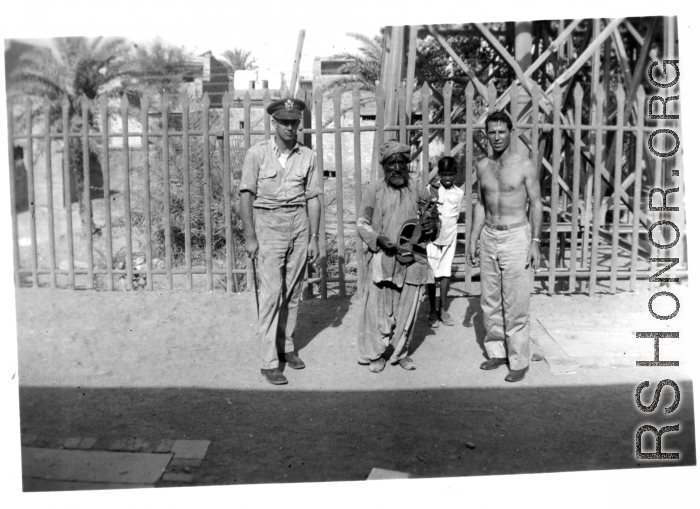 GIs pose with musician and child.  Scenes in India witnessed by American GIs during WWII. For many Americans of that era, with their limited experience traveling, the everyday sights and sounds overseas were new, intriguing, and photo worthy.