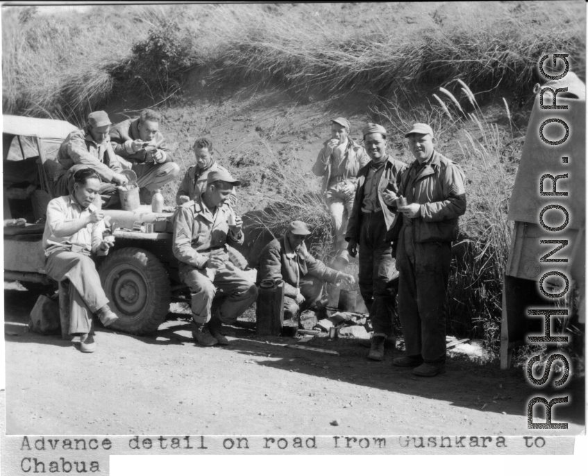 Advance detail on road from Gushkara to Chabua. American and Chinese soldiers stop for a meal over an open flame.