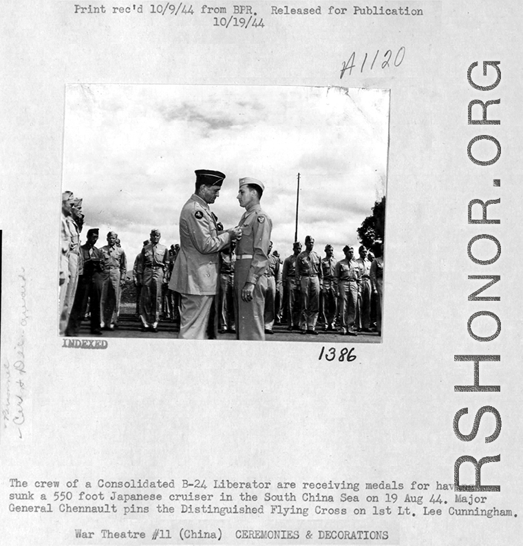 A B-24 bomber crew receives medals for having sunk a 550 foot Japanese cruiser in the South China Sea on August 10, 1944. Here General Chennault pins the Distinguished Flying Cross on 1St. Lst. Lee Cunningham.