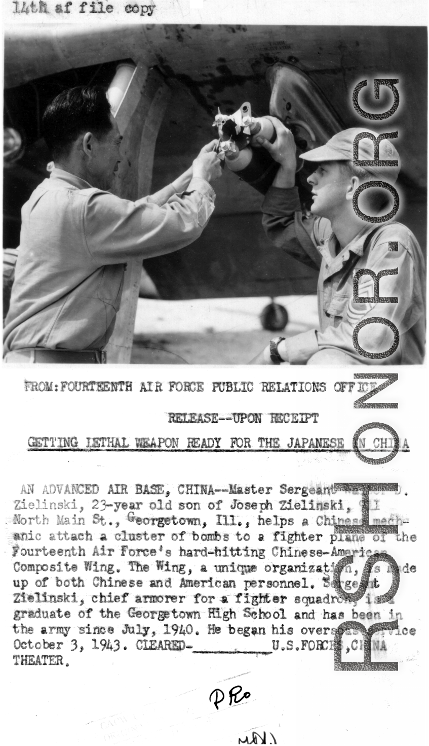 Master Sergeant Walter D. Zielinski helps a Chinese mechanic attach a cluster of bombs to a fighter plane of the CACW.