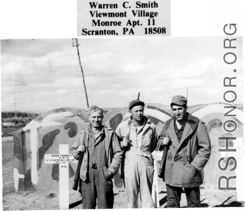 GIs visiting US military graves at Kunming. In the background are markers for the deceased, including for one of George K. Barnes, 74th Fighter Squadron, deceased July 24, 1943.  Photo from Warren C. Smith.