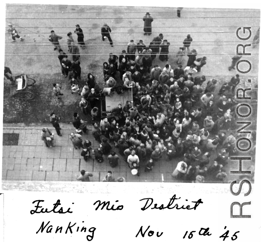 Crowd surrounds American jeep in Futsi Mio District, Nanjing, November 15, 1945.