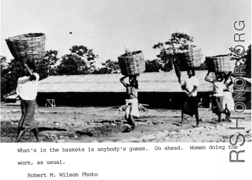 Women carrying baskets on their heads, likely in India. During WWII.  Photo from Robert M. Wilson.