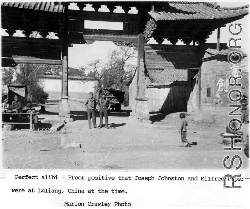 Joseph Johnston and Milfred Piper standing in a gate at Luliang, China, during WWII.  Photo from Marion Crawley.