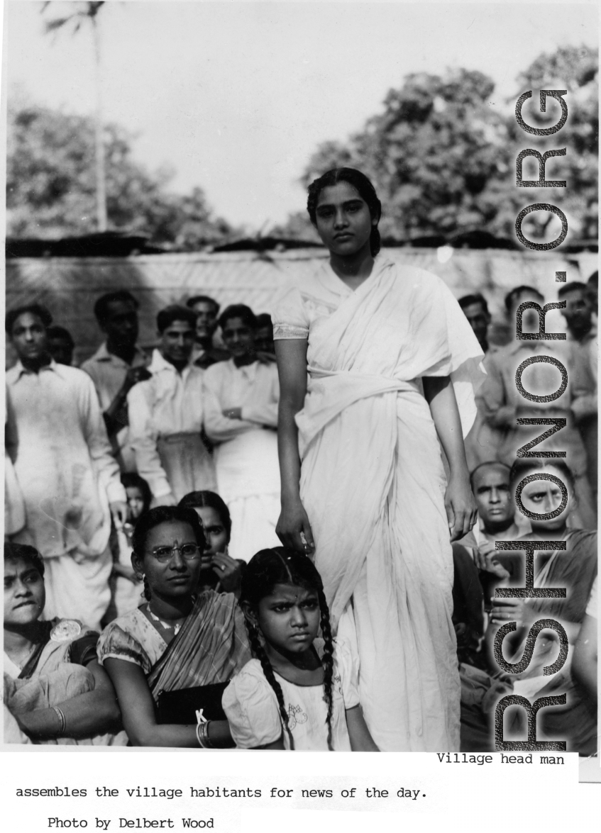 Village inhabitants in India listen attentively to headman who has assembled them.  Photo from Delbert Wood.