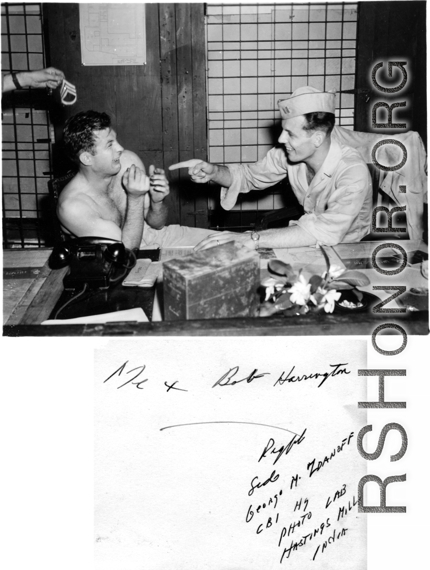 George M. Zdanoff (right) points a finger at Bob Harrington (left) at the photo lab at Hastings Mills, India, HQ during WWII.