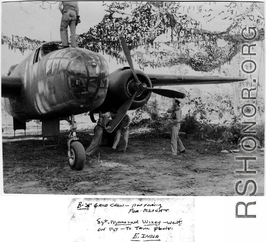 A ground crew preps a B-25 for flight in the CBI during WWII. East India. "Sgt. Marshall Wikey went on flight to take photos."