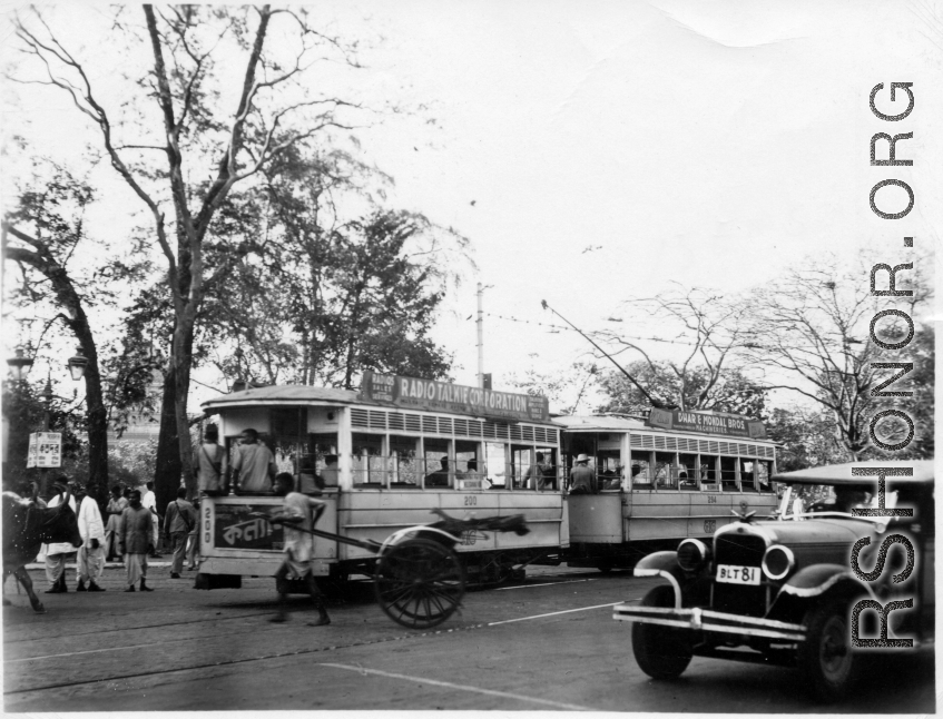 Scene on the road in Calcutta, India (based on the Dhar and Mondal Bros. Machineries" sign on the trolley). In the CBI during WWII.