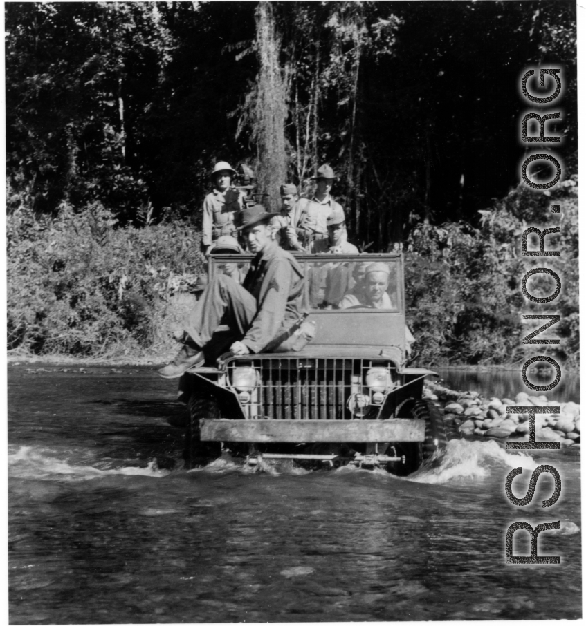 Several GIs cross river in jeep during WWII, in SW China or Burma.