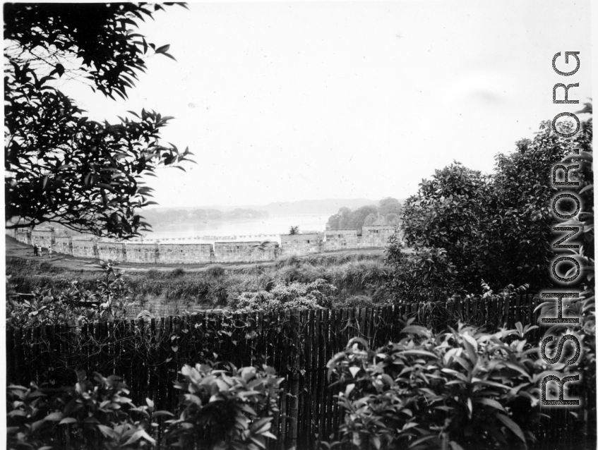 A protective wall, from the inside, with lake or river in the background. In China during WWII.