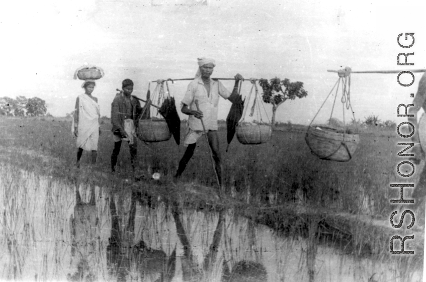 People cross field in at Misamari, India, during WWII.  Local images provided to Ex-CBI Roundup by "P. Noel" showing local people and scenes around Misamari, India.  In the CBI during WWII. 