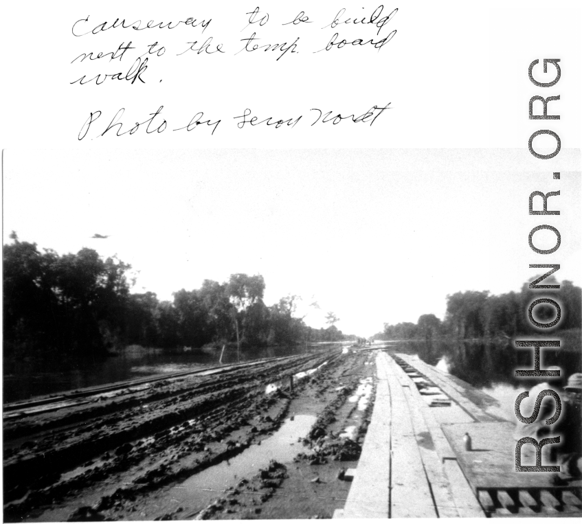 Causeway for convoy trucks to be built to the left of this temporary wood boardwalk somewhere in the CBI during WWII.  Photo by Leroy Nordt.