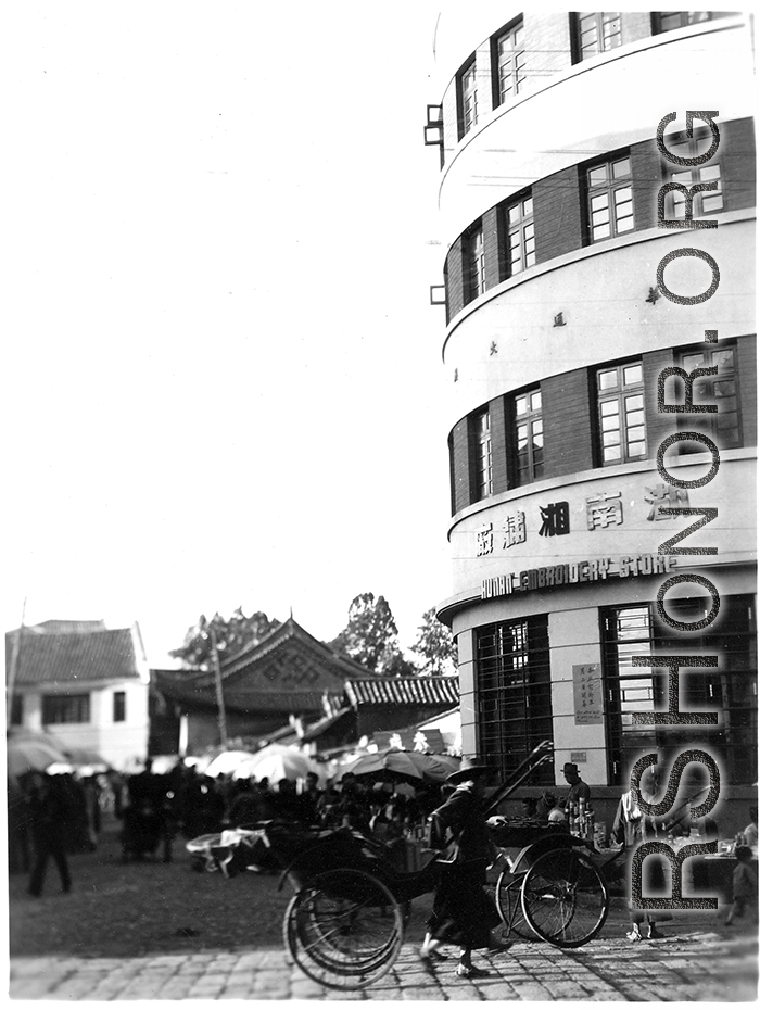 Local people in in Kunming city, Yunnan province, China: A market area and the "Hunan Embroidery Store" during WWII.