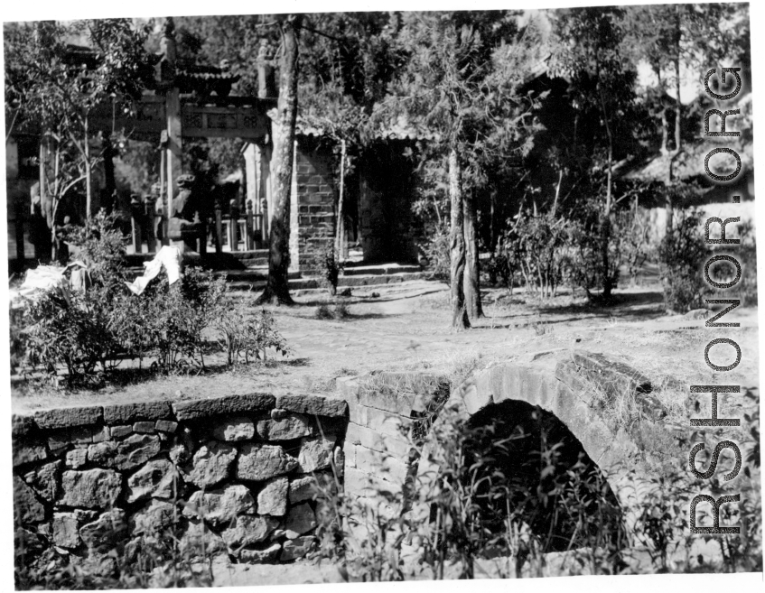 A village and stone bridge in Yunnan province, China, during WWII.  From the collection of Eugene T. Wozniak.