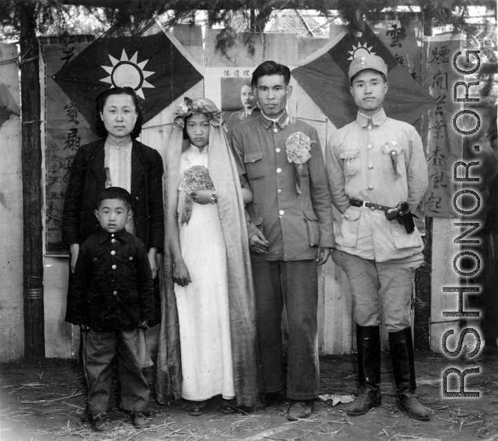 A wartime wedding in Yunnan province, China, with a very young and unenthusiastic bride.  See alternative image here.