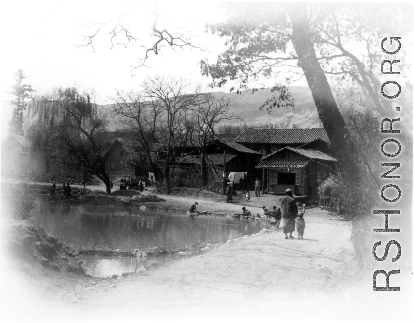 Ladies washing clothing in a village pond near Yangkai, Yunnan province, China. During WWII.