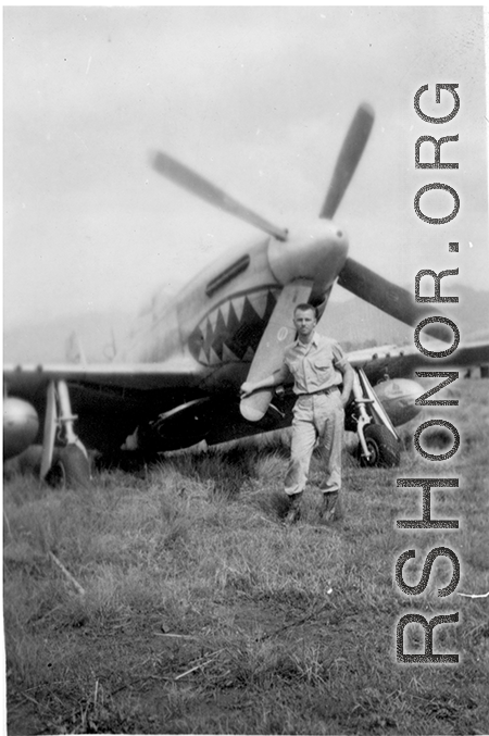 Elmer Bukey poses for a photo in front of a P-51 at Liangshan, China, during WWII.