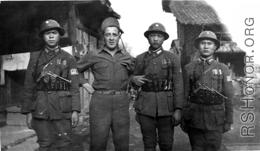 An American GI and Chinese military police pose for the camera: "This Is A Picture Of Nick Vassello And Some Of China's Finest Soldiers."