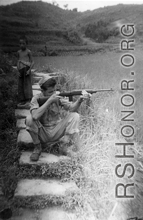 "Ralph O'Connor Taking Dead Aim At His Target While A Chinese Boy Looks On Hoping To Maybe Get Whatever He May Shoot."