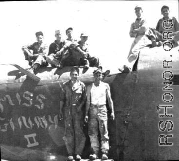 "Here is a crew from the 396th doing some salvage work on the B-24 Miss Ginny.The two guys standing are Dowds on left and Kriewitz on the right. Sitting on plane far left are Rizzo and Gerdsen. On the far right are Mayfield and Blaske. Nothing went to waste in China."