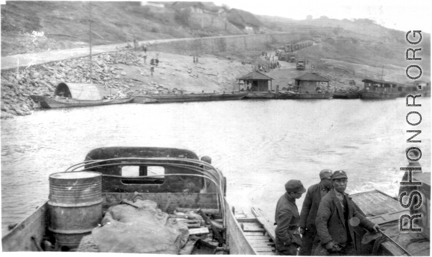 12th Air Service Group convoy crossing river by barge in China during WWII.