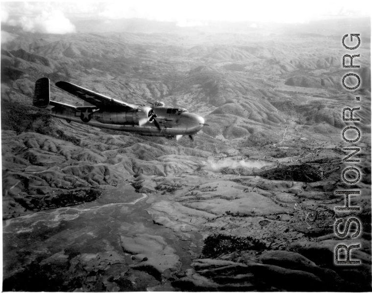 Smoke rises on the ground after an attack by American B-25s in either SW China, Indochina, or the Burma area.  This might be fairly close to Tengchong in China.