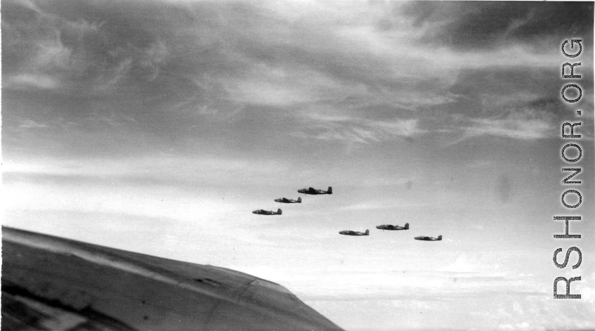 B-25 Mitchell bombers in flight in the CBI, in the area of southern China, Indochina, or Burma.  This image itself is probably taken from within a B-25, from the machine gun turret in the top of the fuselage.