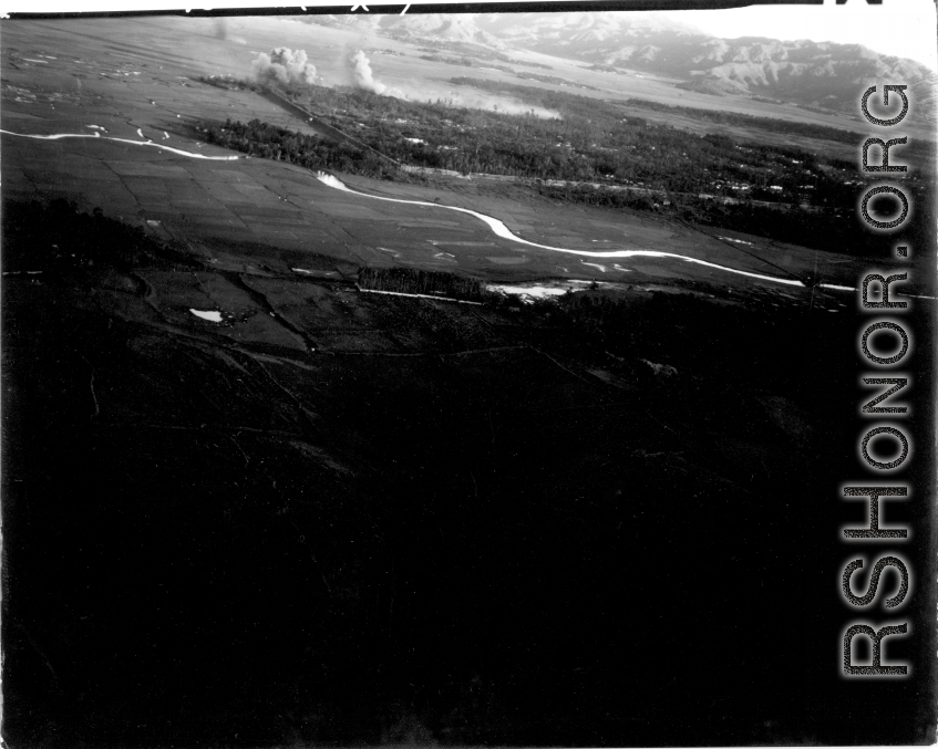 Smoke rises from B-25 Mitchell bombers attack during battle with Japanese ground forces, flying over Tengchung (Tengchong), near the China-Burma border in far SW China.