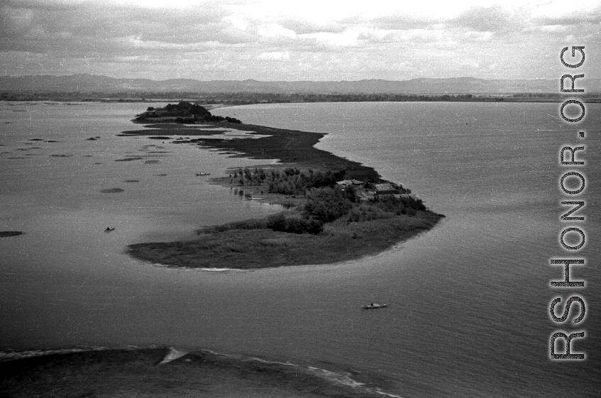 View over Dianchi Lake (滇池) outside of Kunming, China, during WWII. A few small boats dot the water surface. 
