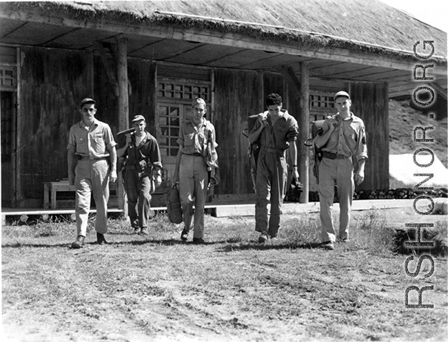 American flyers at Guilin, China, set forth with their gear towards the flight line during WWII.  From the collection of Hal Geer.