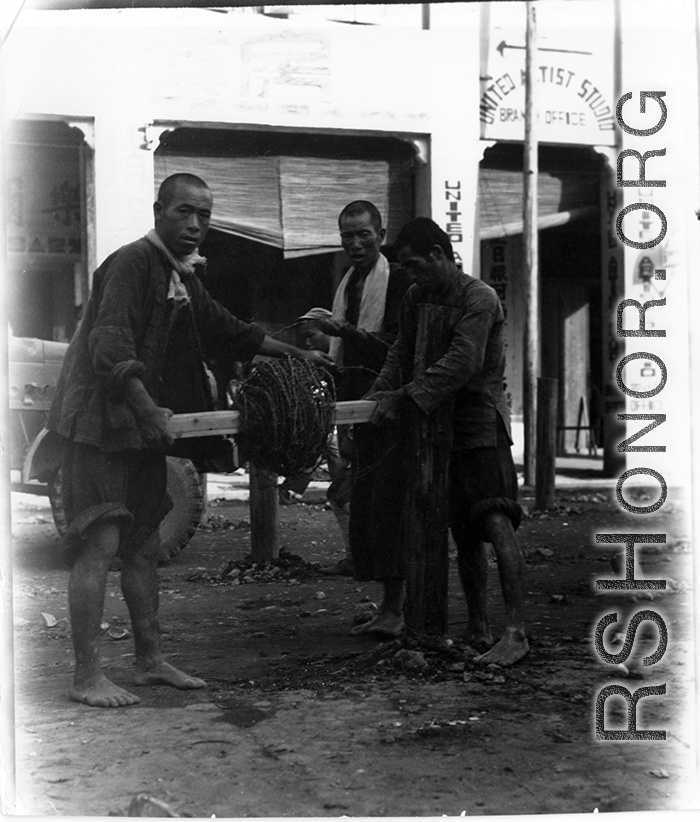 Putting down barbed wire in the fall of 1944 in Liuzhou. Notice the English "United Artist Studio" in the back--after the Japanese retreat from Liuzhou, only those pillars stood.