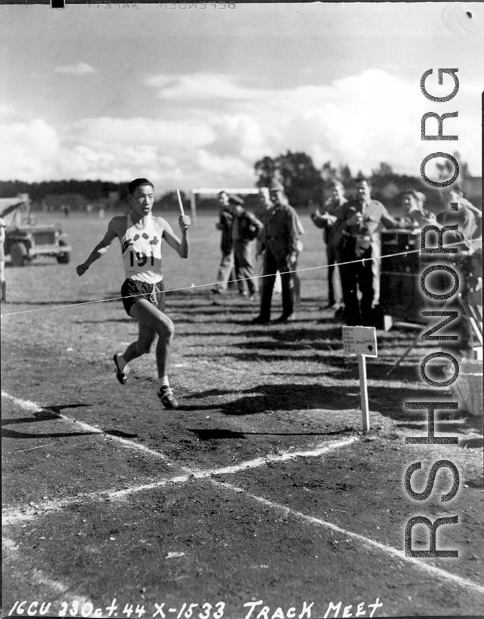 A runner crosses the finish line at a track meet in China during WWII, on October 23, 1944.