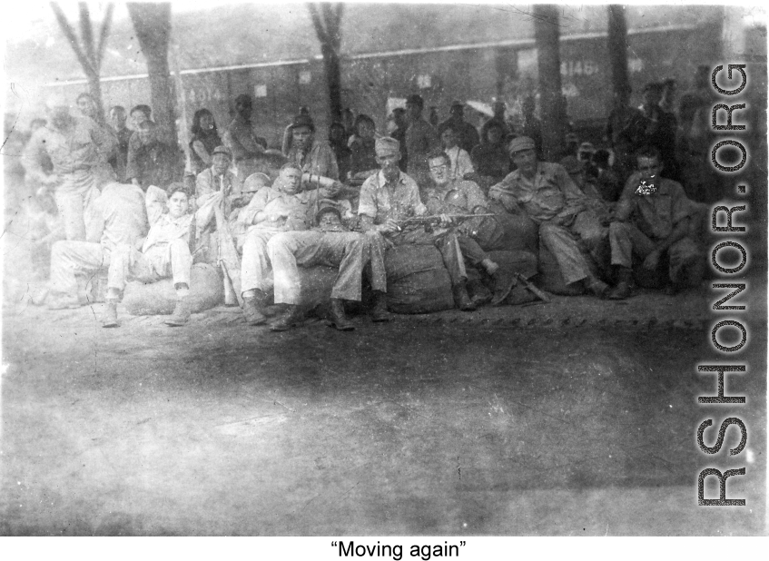 "Moving again."  GIs in transit through a train station in China during WWII. Notice the carbine in one GI's hands.