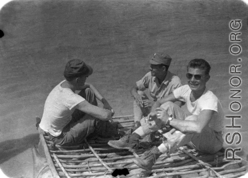 GIs and Chinese soldiers float on a sheep-skin raft in northern China, probably on the Yellow River. During WWII.