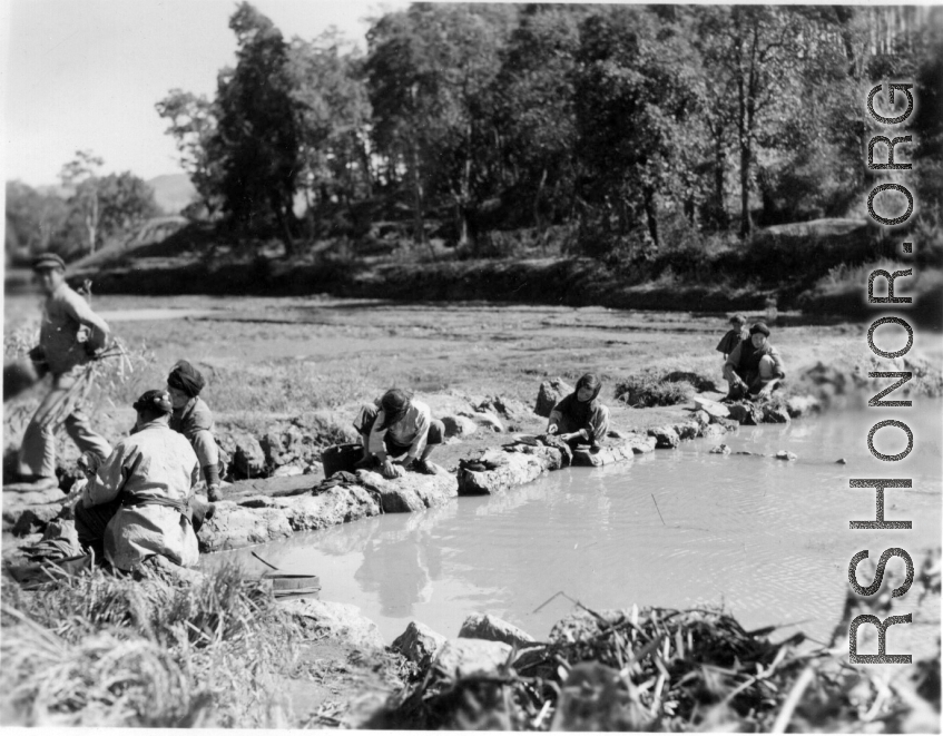 Local people wash clothes. Probably at Yangkai, China. During WWII.