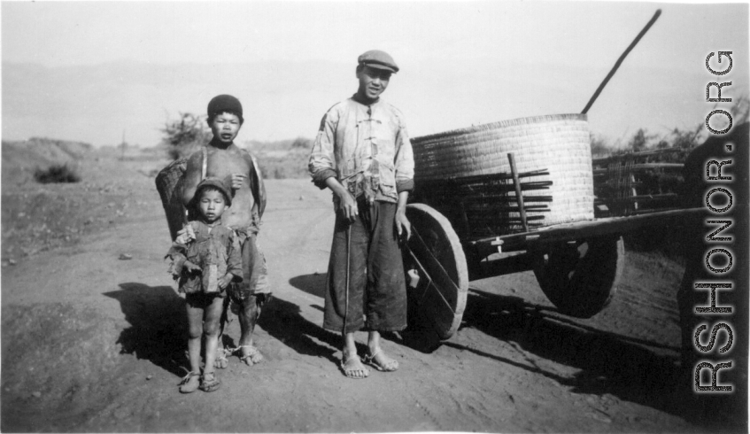 Rural farm people with their donkey cart. At the north end of the field, Yangkai, Spring 1944. During WWII.  From the collection of Frank Bates