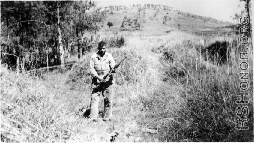 "Fred Nash, several miles south of Yangkai, in a group of burial mounds, just before having lunch. Spring, 1945."  From collection of Frank Bates.