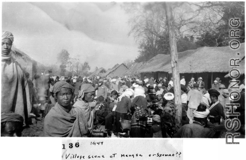 "Village scene in Mengsa or Szemao" in SW China, in 1944, during WWII. Likely market day activities.