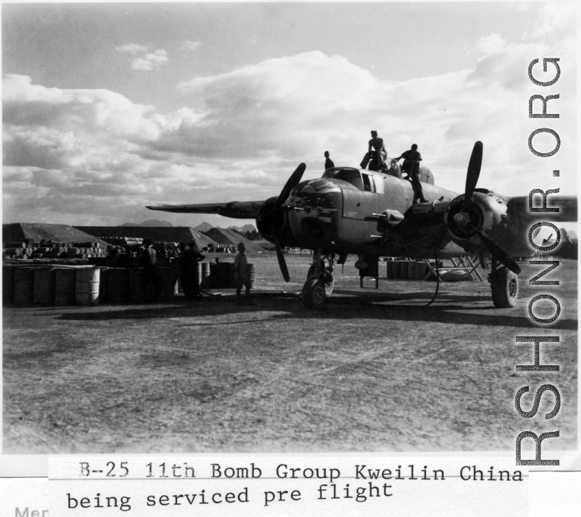 Maintenance personnel move across upper surfaces during pre-mission servicing of a B-25H 'gunship' of the 11th Bomb Squadron (not Group), 341st Bomb Group at Yang Tong Airfield, Guilin in Guangxi province, China. Circa fall of 1944.