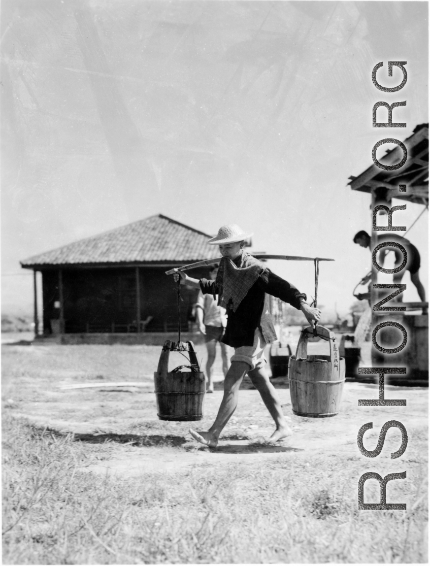 Laborer at an American air base carrying pails--they may not have smelled nice--in the CBI.
