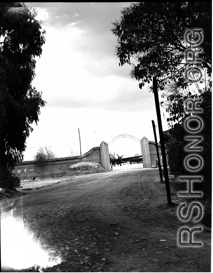 Guarded gates of the Nationalist Kunming Air Force Officer Training School during WWII, with C-46 transports.