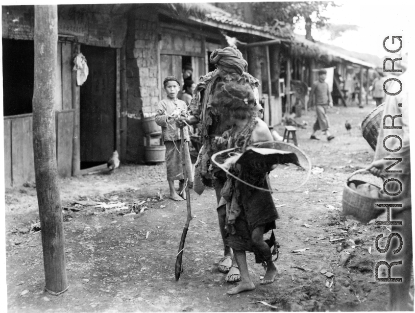 Local people in Yunnan province, China: Two of the village's destitute walking down the road.