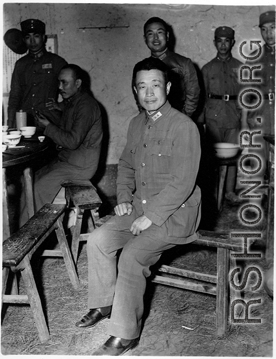 Chinese Lt. General Du Yuming, commander of Nationalist 5th Corps (第五集团军总司令兼昆明防守司令杜聿明), poses for American cameraman on bench, at rally.