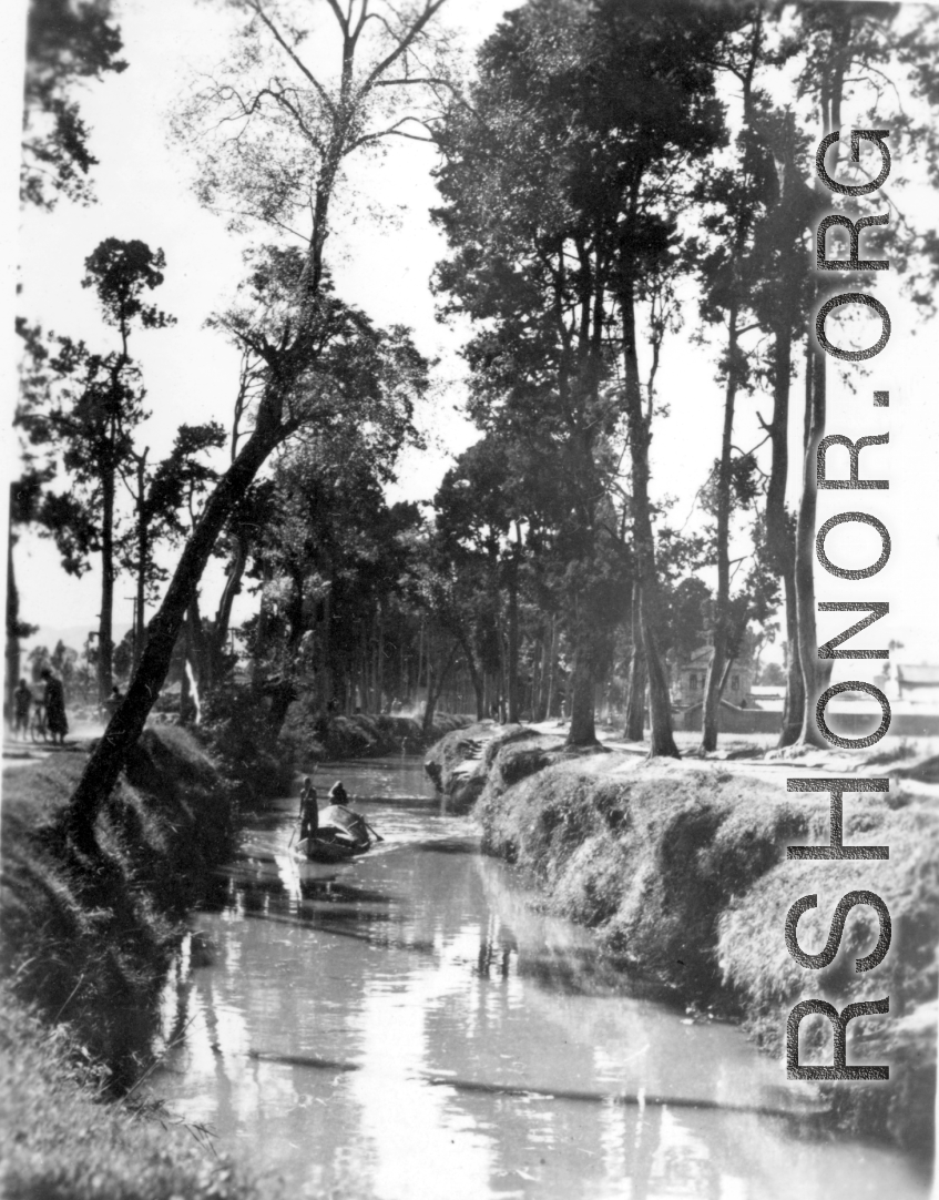 A boat on a canal in Yunnan province, China. During WWII.